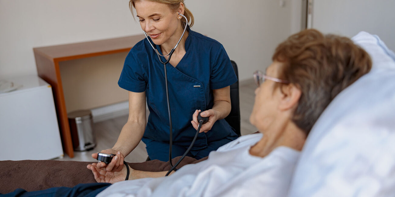 female-nurse-checking-blood-pressure-of-senior-wom-2022-06-24-14-22-41-utc.jpg